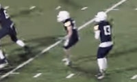 a group of football players are running on a field
